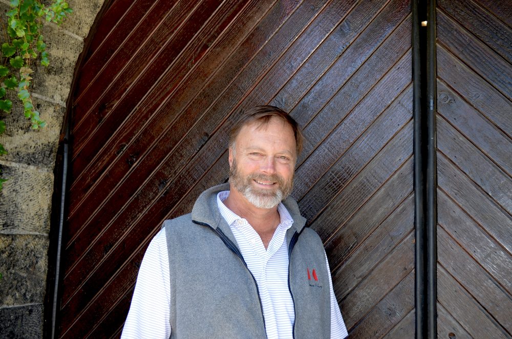 Michael Keenan outside the arched wooden door of the historic Keenan winery building on Spring Mountain